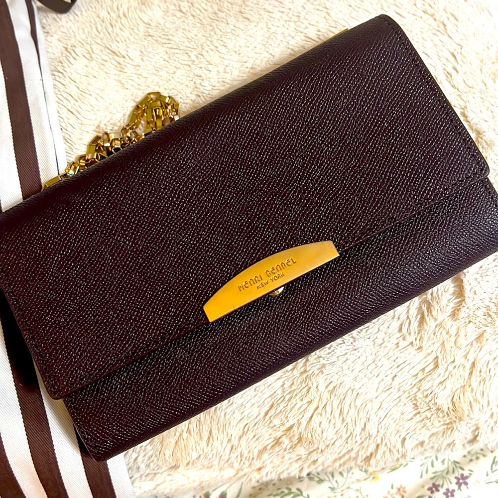 Henri Bendel wallet on chain crossbody bag in maroon cooor with gold touch.